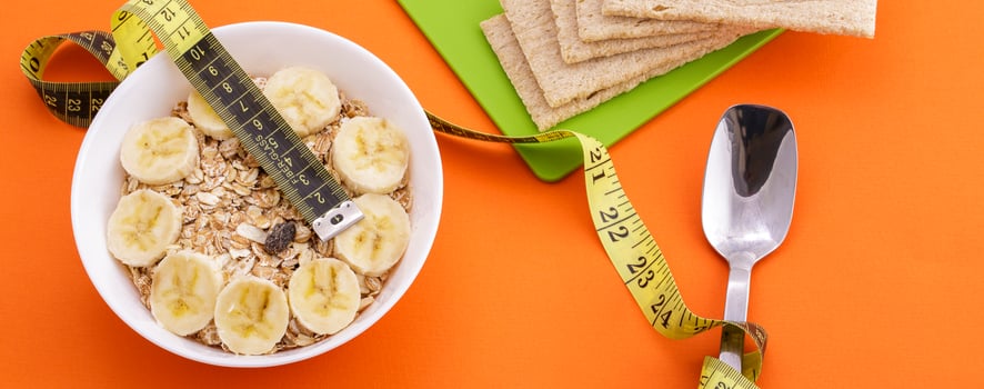 oatmeal  and crispbread lie with spoon and measuring tape on orange background photo