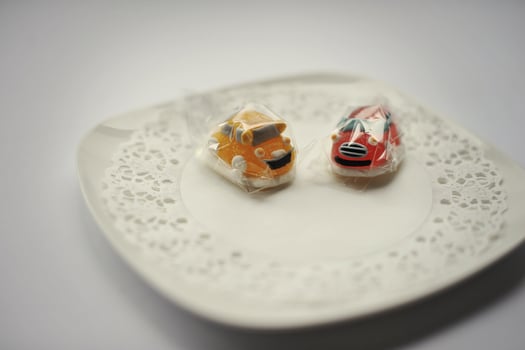 sweet candies of two cars food isolated on white photo
