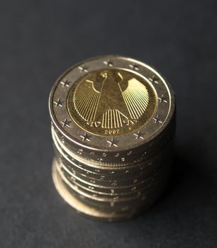 Pile of German 2 Euro coins over black photo