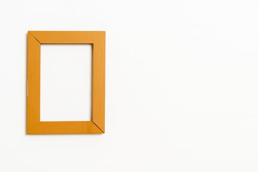 empty picture frame on white wall background photo