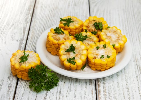 Plate with boiled corn on the cob photo