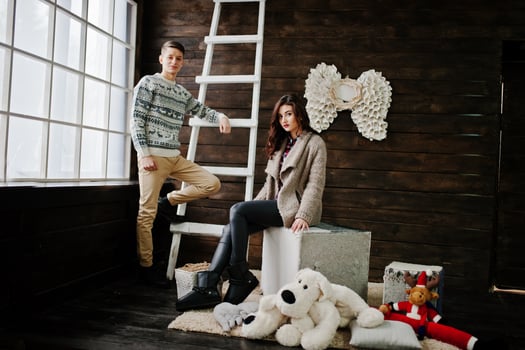 Young fashion winter  couple at wooden background photo
