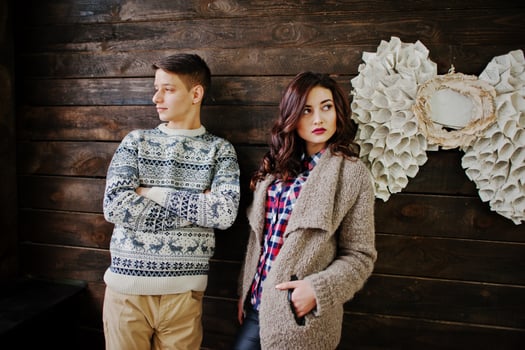 Young fashion winter  couple at wooden background photo