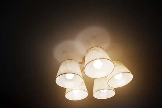 Included chandelier lamp at black ceilng photo
