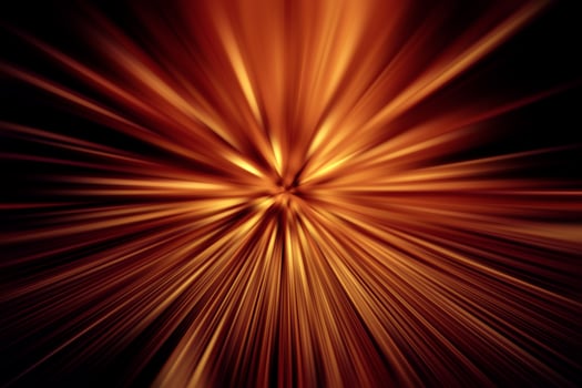 Explosion of red yellow light rays on a black background photo