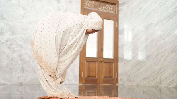 Asian Muslim women perform the obligatory prayers in the mosque photo