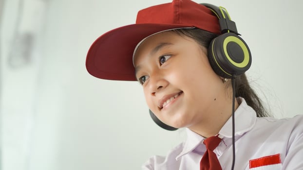 asian elementary school girl studying online at home happily photo