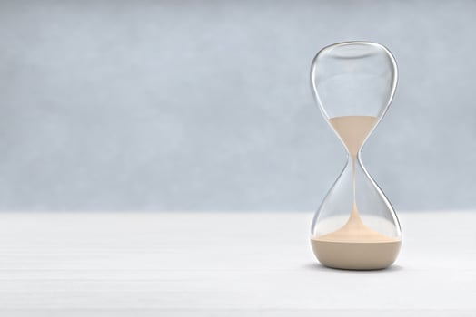 Hourglass on Wooden floor with copy space, sandglass photo
