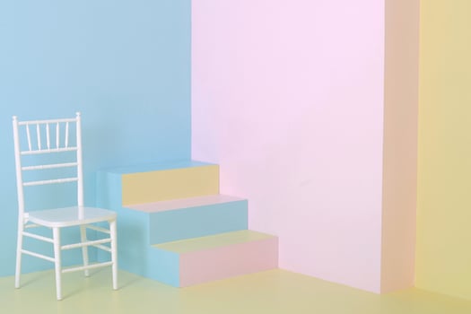 Colorful pastel colors background, minimalist home corner with staircase and white wooden chair, fine art photo