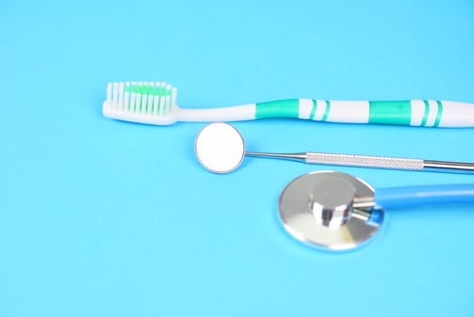 Dental care concept - dentist tools with dentures dentistry instruments and dental hygiene and equipment checkup with mouth mirror oral health photo