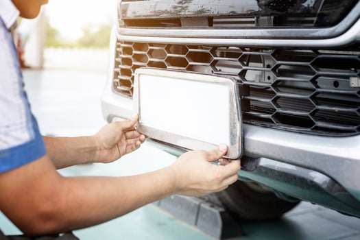 Technician changing car plate number in service center photo