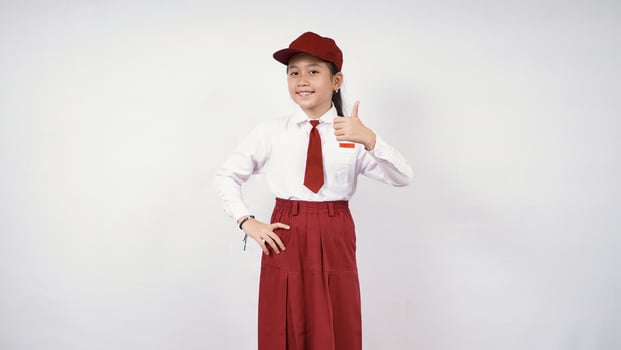 Smiling and okay asian elementary school girl isolated on white background photo