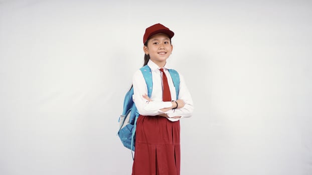 Asian elementary school girl giving two thumbs up isolated on white background photo