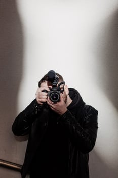 stylish man holds a video camera photo