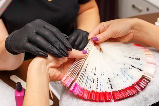 the client in the salon of manicure chooses the color of nail Polish photo