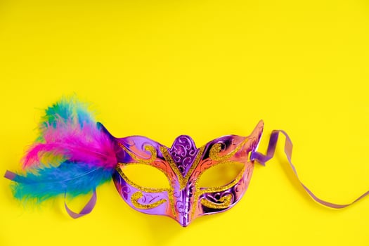 Carnival mask on yellow background. photo