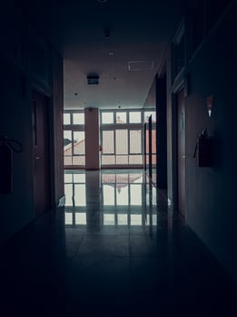 Office corridor with a tense and silent and horror atmosphere and nobody. Dark effect. Windows and glass. photo