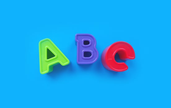 abc letters isolated on blue background. banner, alphabet brightly toy, learning. photo