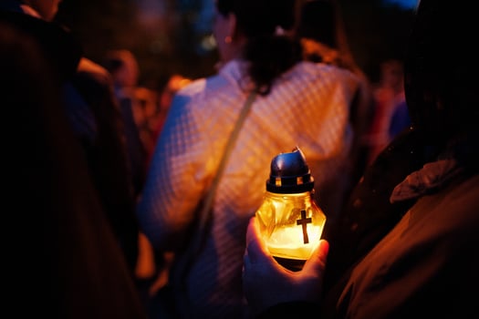 Funeral candle lamp in hand at night photo