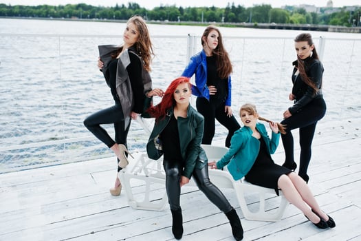 Five beautiful young girls models at leather jackets posing on berth. photo