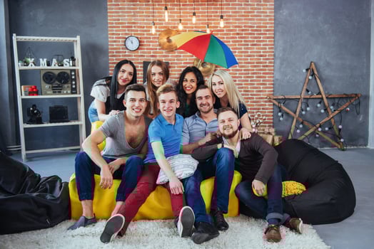 Group portrait of multi-ethnic boys and girls with colorful fashionable clothes holding friend posing on a brick wall, Urban style people having fun, Concepts about youth togetherness lifestyle photo