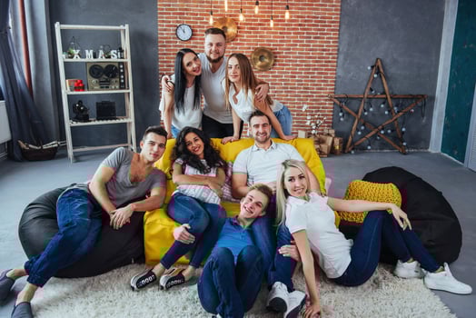 Group portrait of multi-ethnic boys and girls with colorful fashionable clothes holding friend posing on a brick wall, Urban style people having fun, Concepts about youth togetherness lifestyle photo