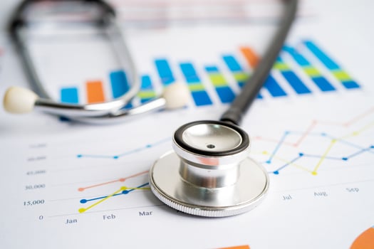 Stethoscope on charts and graphs paper, Finance, Account, Statistics, Investment, Analytic research data economy and Business company concept. photo