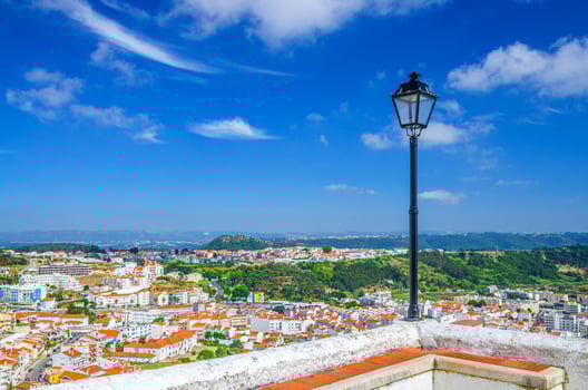 Aerial panoramic view of Nazare town residential district buildings houses and green hills background photo