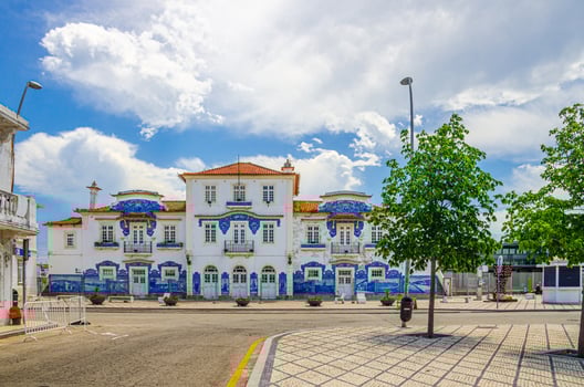 Aveiro station, central railway azulejos-tiled station building in city centre with green trees photo