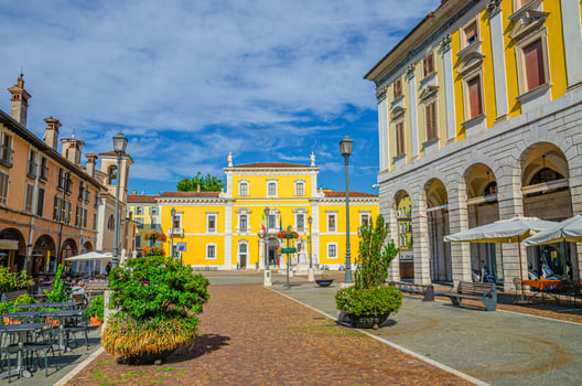 Typical italian buildings, street restaurants and flowers and Palazzo Martinengo Palatini palace photo