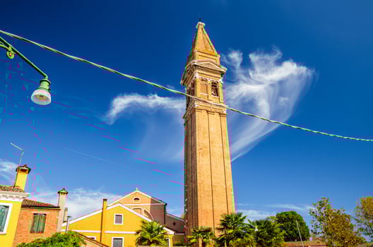 San Martino Roman Catholic church in Burano island with brick bell tower campanile photo