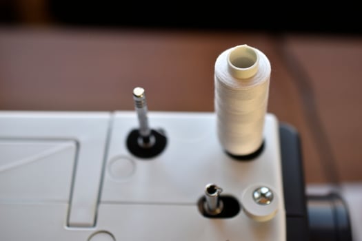 New White sewing machine with threads at home photo