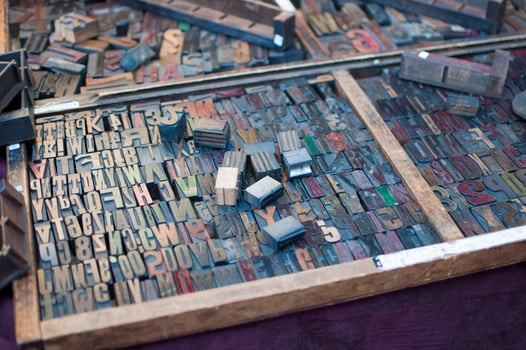 Metallic moulds for lettering in binding. Background photo