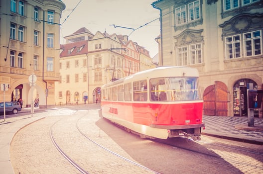Typical old retro vintage tram on tracks near tram stop in the streets of Prague city photo