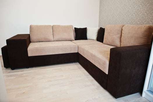 Bicolor cofee corner sofa bed at light room photo