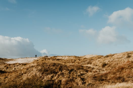Man walking on dunes photo