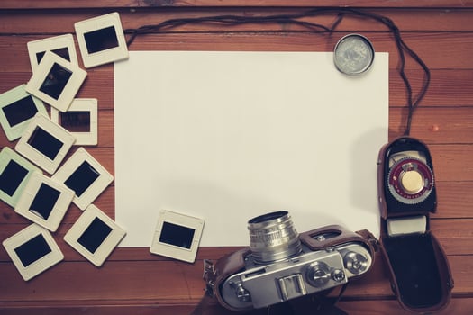 retro camera and some old photos on wooden table