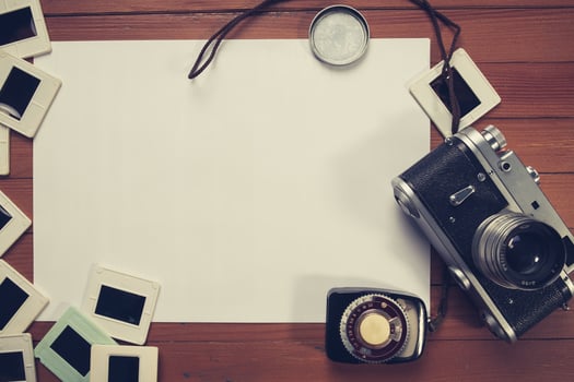 retro camera and some old photos on wooden table