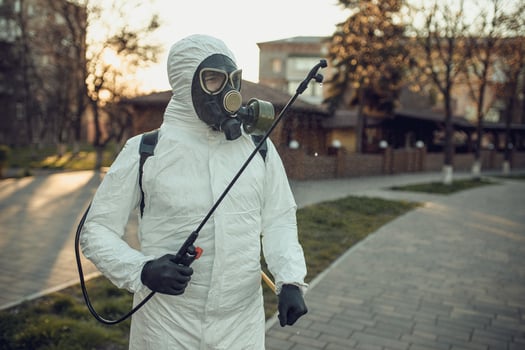 Cleaning and Disinfection on the playground in the sity complex amid the coronavirus epidemic Teams for disinfection efforts Infection prevention and control of epidemic Protective suit and mask photo