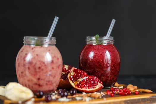 freshly prepared smoothies from banana with pomegranate and banana with blackberry in bottle. Diet, healthy lifestyle photo