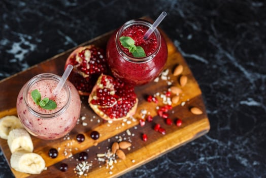 freshly prepared smoothies from banana with pomegranate and banana with blackberry in bottle. Diet, healthy lifestyle photo