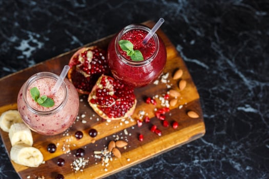 freshly prepared smoothies from banana with pomegranate and banana with blackberry in bottle. Diet, healthy lifestyle photo
