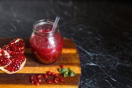 freshly prepared smoothies from banana and pomegranate. Diet, a healthy lifestyle photo