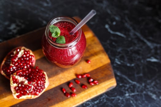 freshly prepared smoothies from banana and pomegranate. Diet, a healthy lifestyle photo