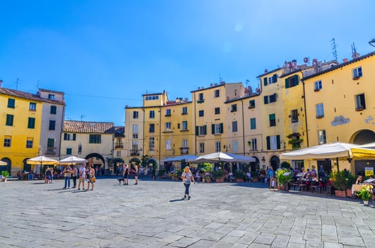 Lucca, Italy, September 13, 2018 Piazza dell Anfiteatro square in circus yard of medieval town historical centre photo