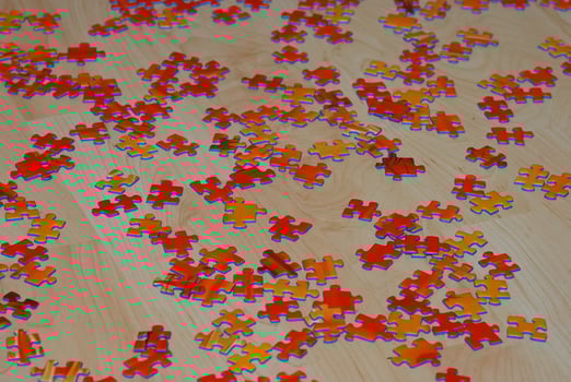many red puzzle stones are scattered on the wooden floor photo