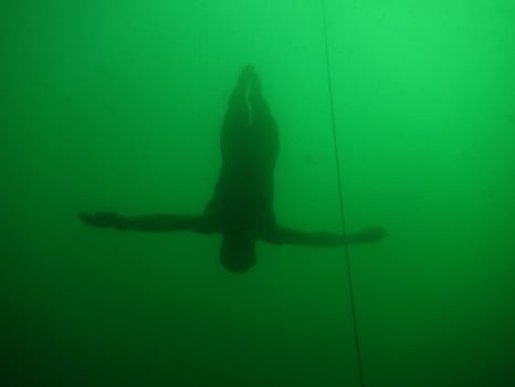 free diving or apnea diving lets itself fall into the deep photo