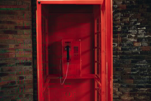 Old school red payphone inside vintage red telephone booth photo