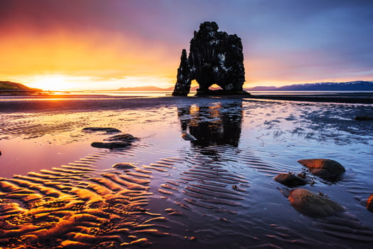 Hvitserkur 15 m height. Is a spectacular rock in the sea on the Northern coast of Iceland.  this photo  reflects in the  water after the midnight sunset.