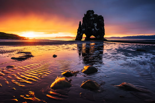 Hvitserkur 15 m height. Is a spectacular rock in the sea on the Northern coast of Iceland.  this photo  reflects in the  water after the midnight sunset.
